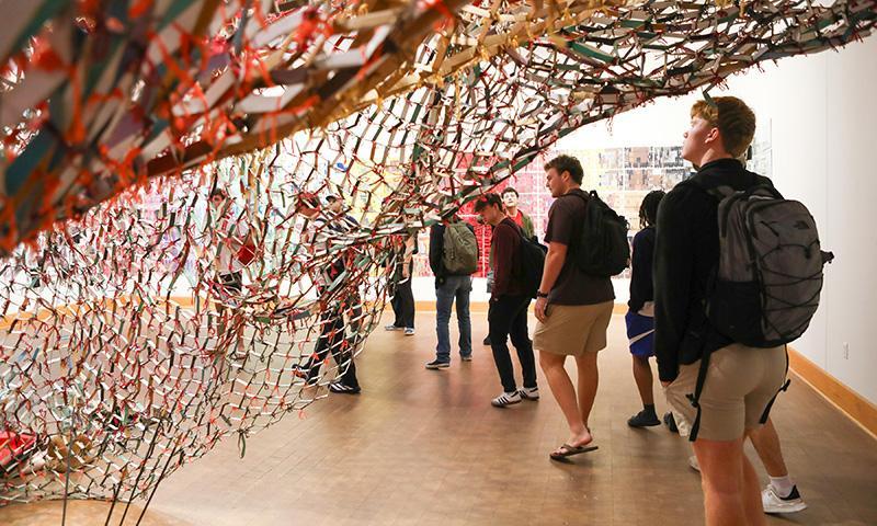 Students from Professor Anne Bost's Enduring Questions class visited the gallery of Artist in Residence Akindiya Akirash and had a chance to interact
